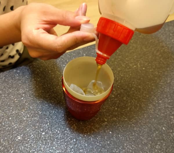 1-pour honey into cocktail shaker.jpg