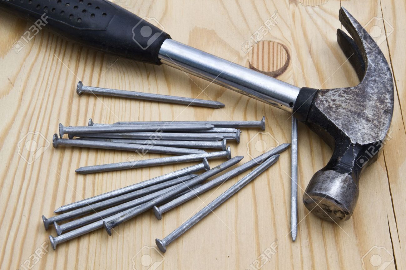 10315300-Old-hammer-and-nails-on-wood-background--Stock-Photo-carpenter.jpg