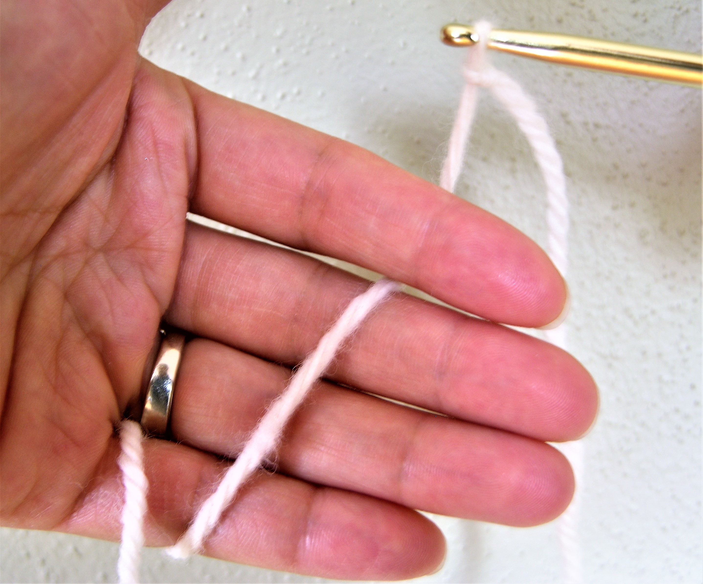 11 thread yarn from front tp back between middle and index fingers.JPG