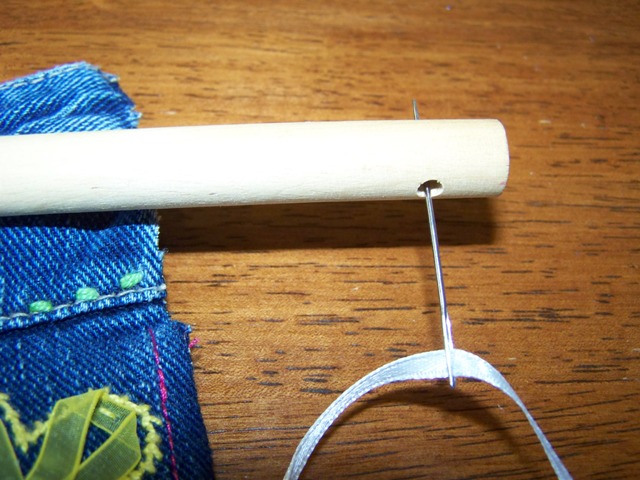 13. thread ribbon through holes at end of dowel rod and tie.JPG