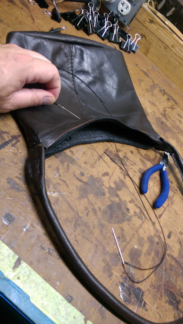 27 stitching the leather zipper and liner.jpg