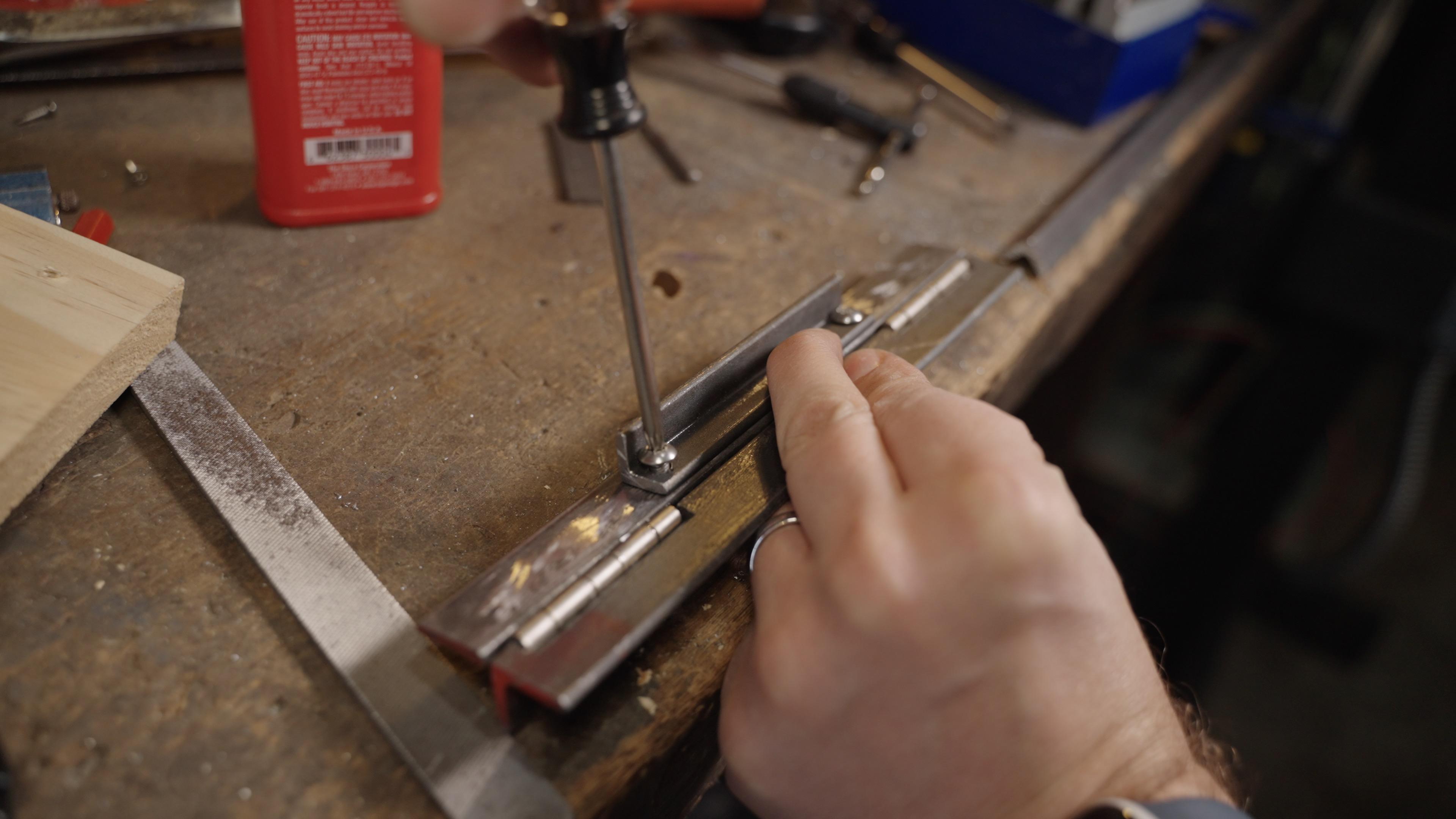 33. Securing Holddown Clamp with Screws.jpg