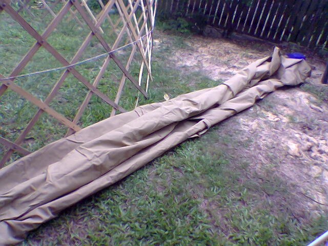 48-unfold roof canvas, and roughly role half of roof ( other half is folded below in this pic).jpg