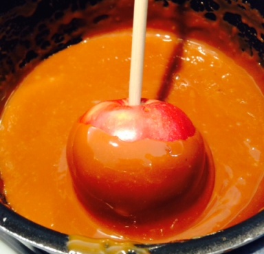 Apple being dipped into caramel.jpg