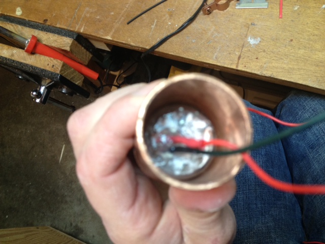 Applying hot glue inside to fix the tube.JPG