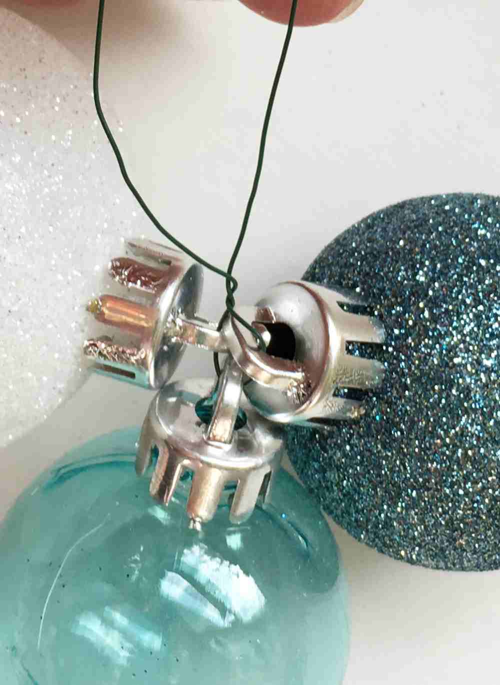 Close up of tying three ball ornaments together.jpg