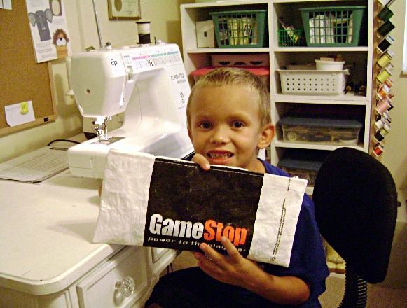 Gavin holding Game Stop bag 1.JPG