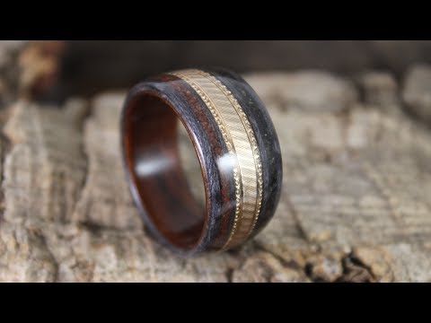 Gold Wedding Ring In A Wooden Ring