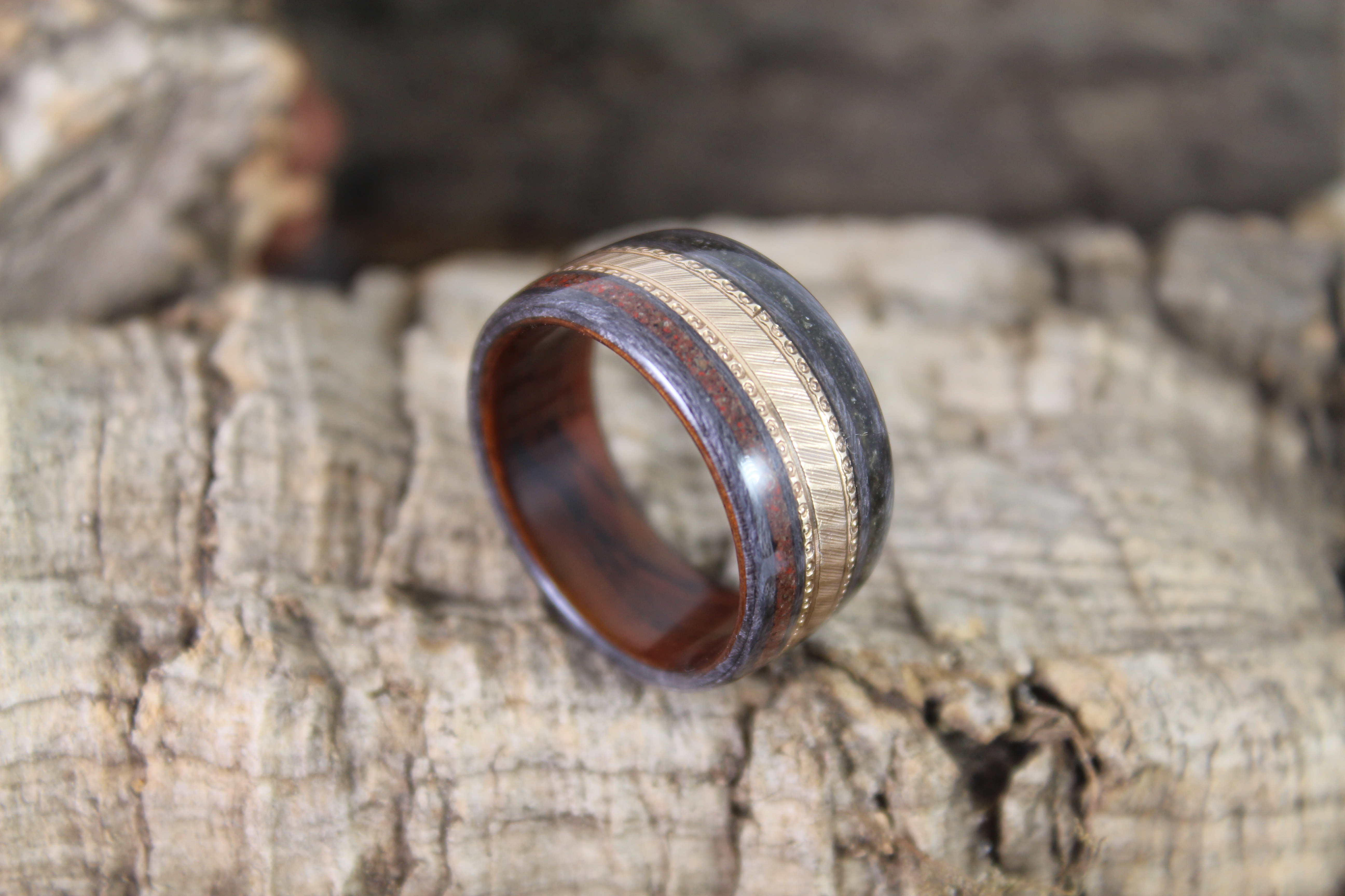 Gold Wedding Ring In A Wooden Ring.JPG