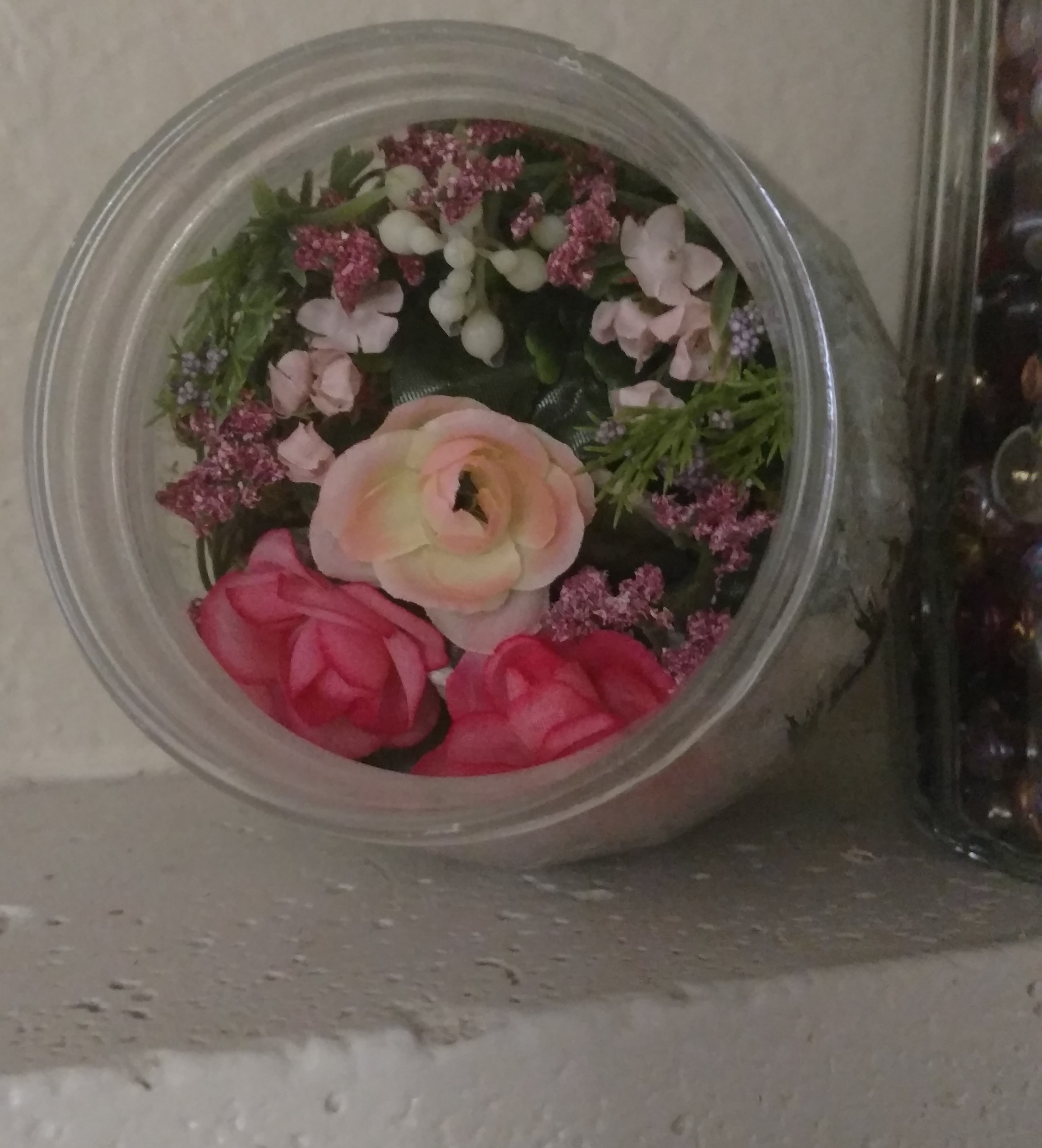 Ingredients filling up jar to create mini flower-rarium.jpg