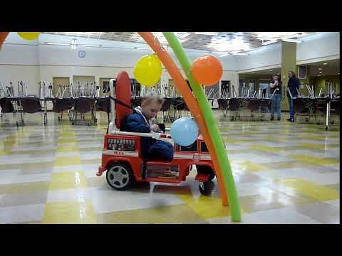 Luca driving his go baby go joystick firetruck