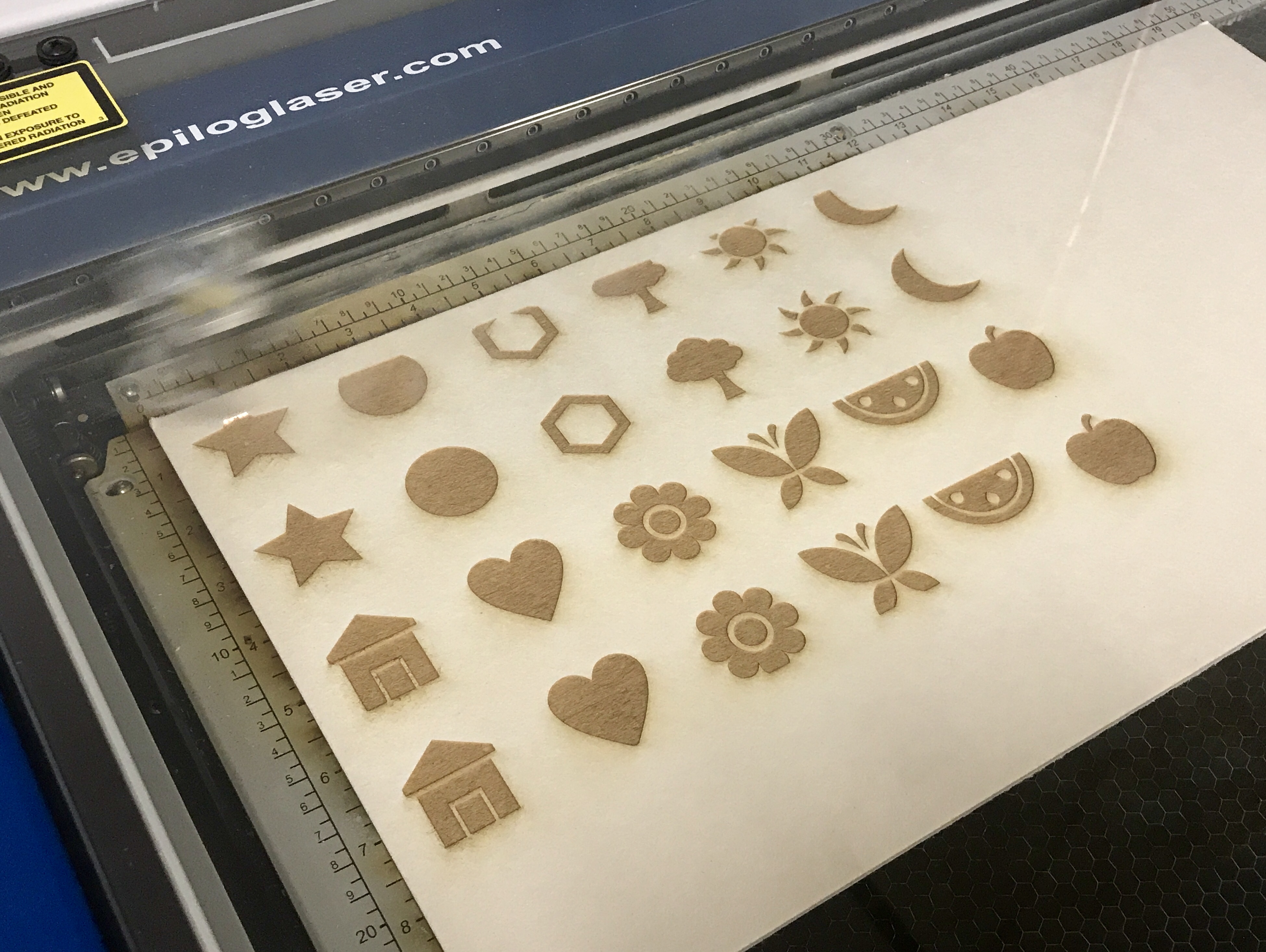 Memory cards being cut on Epilog laser cutter.jpg