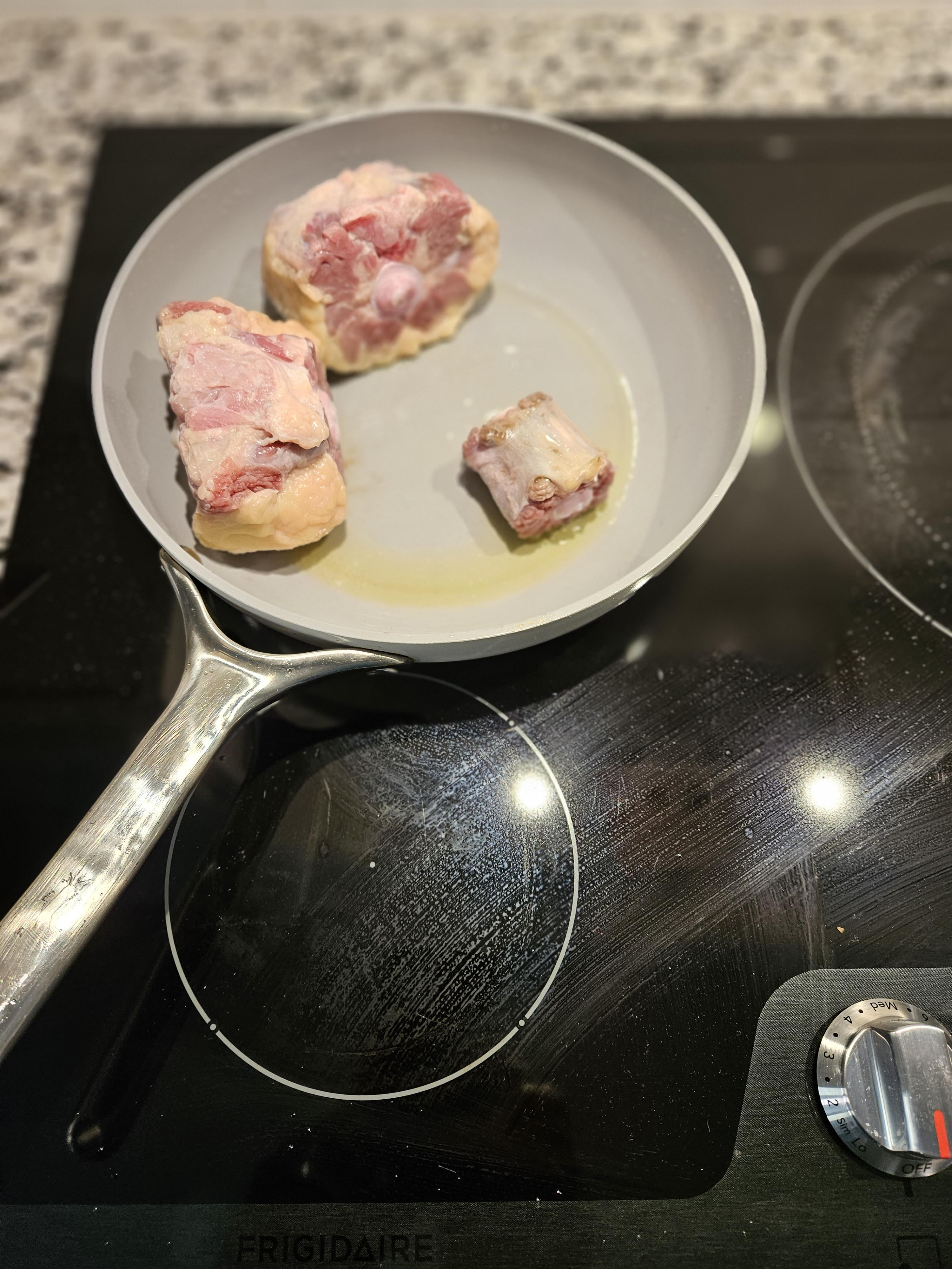 Oxtail browning on skillet pan.jpg