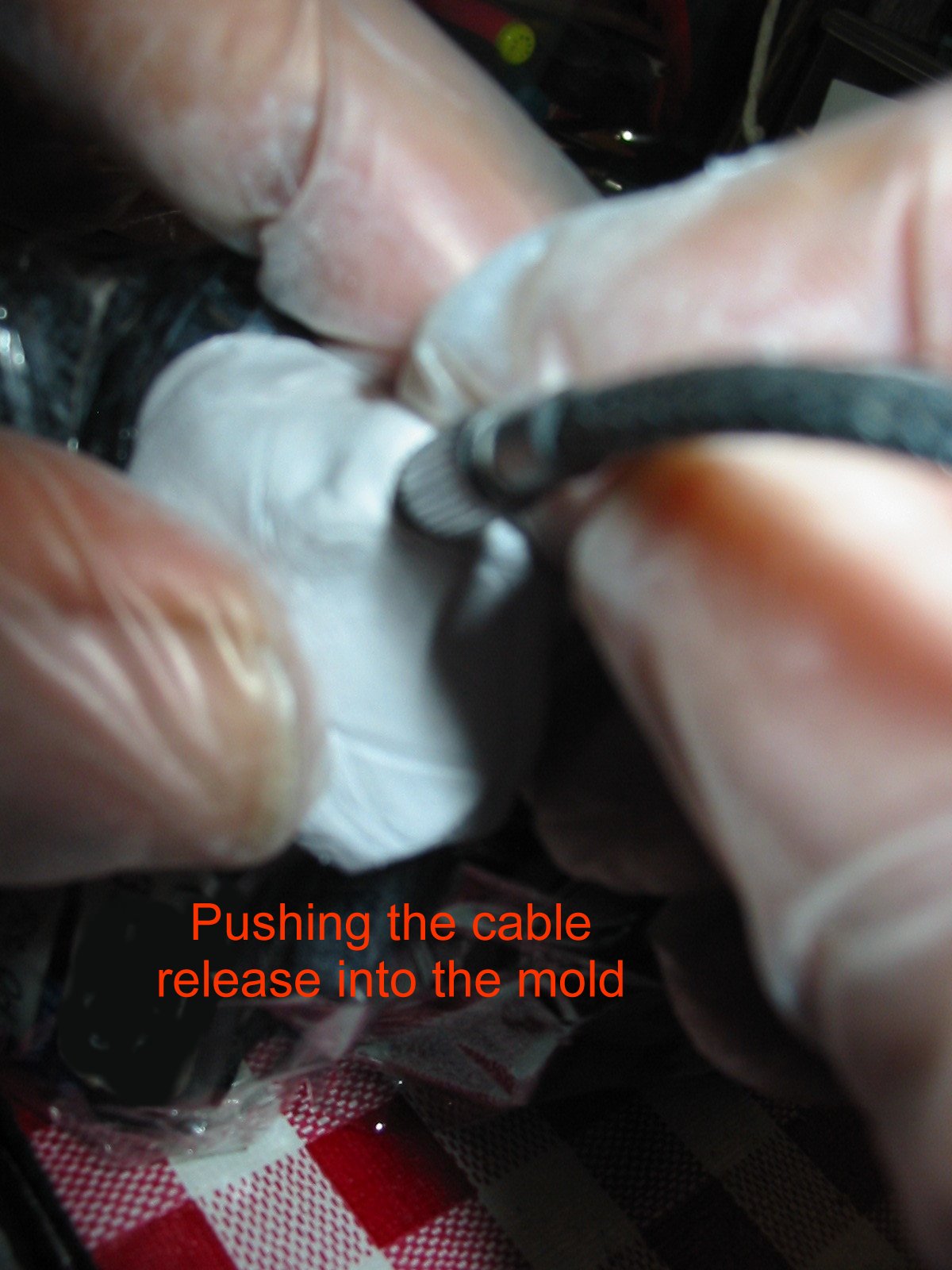 Pushing cable into mold.jpg