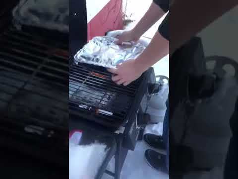 Putting potatoes on the grill