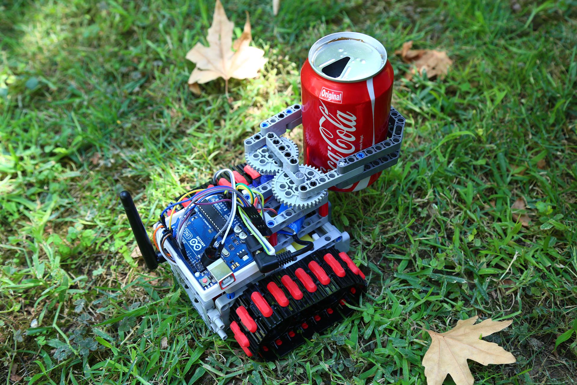 Rescue robot using its gripper to displace a can of coke.jpg