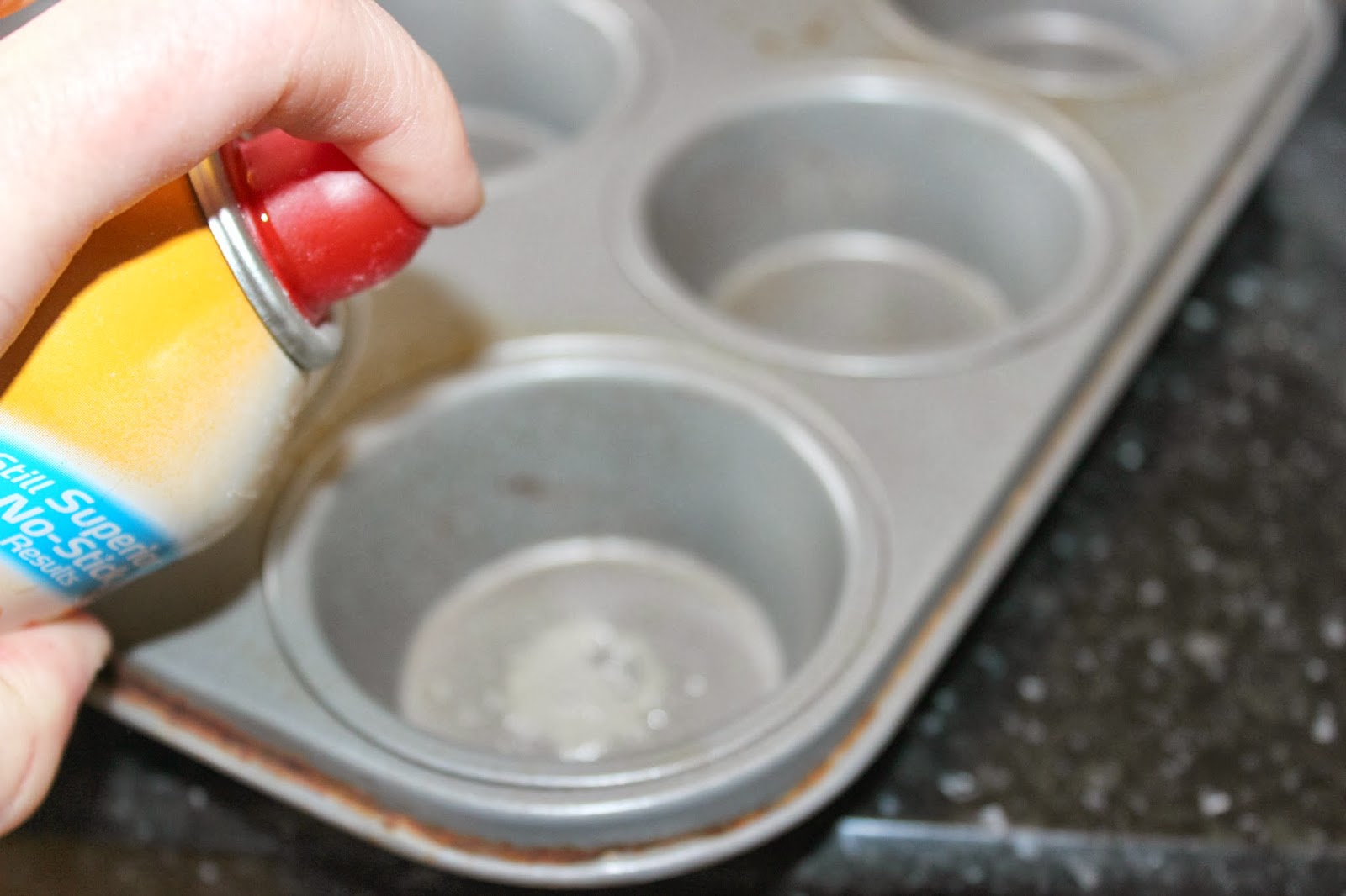 Spraying muffin tins.jpg