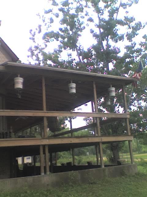 Tomato buckets NE corner of porch from yard 05-25-09.jpg