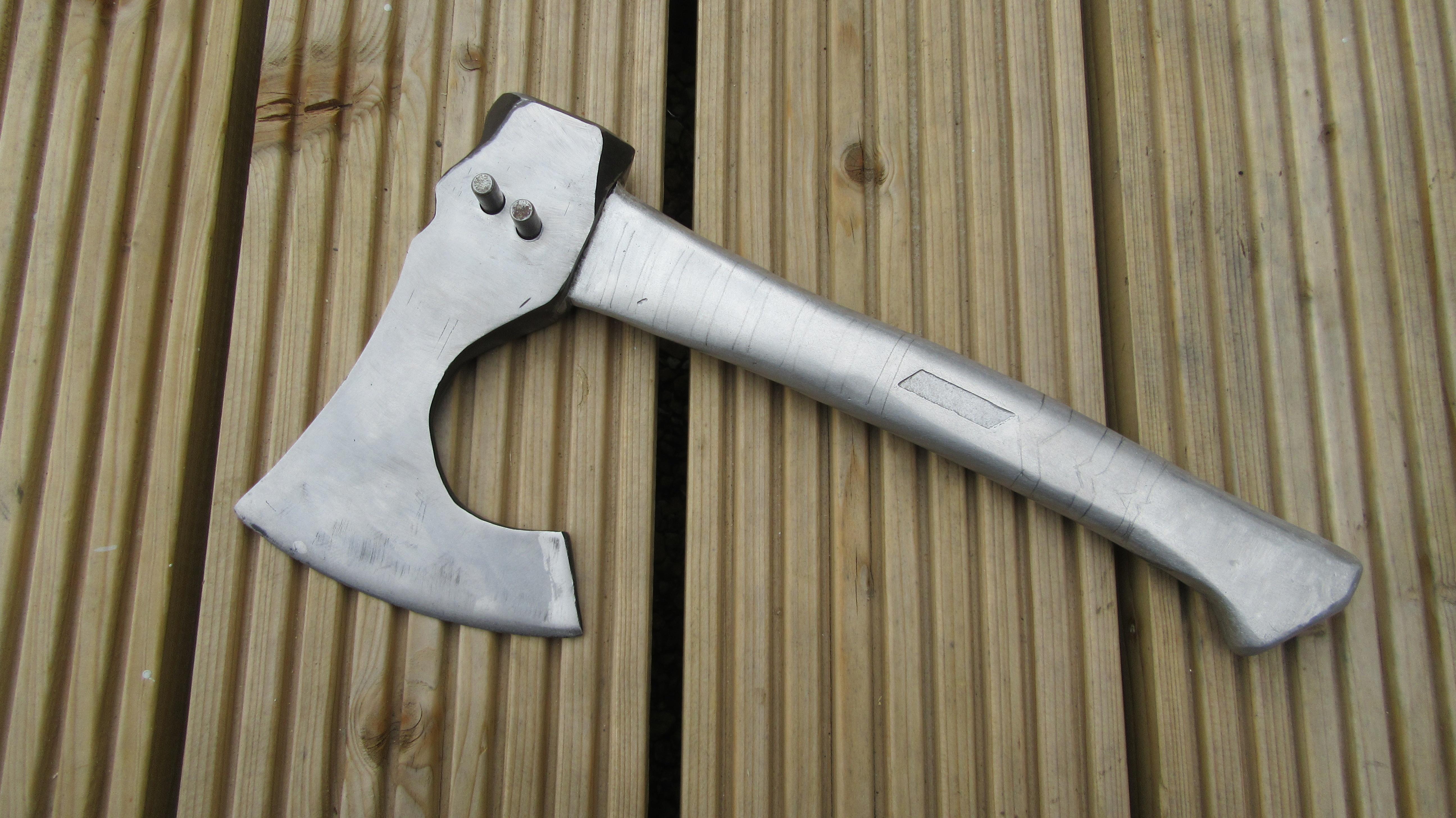 Viking axe head with metal pins.JPG