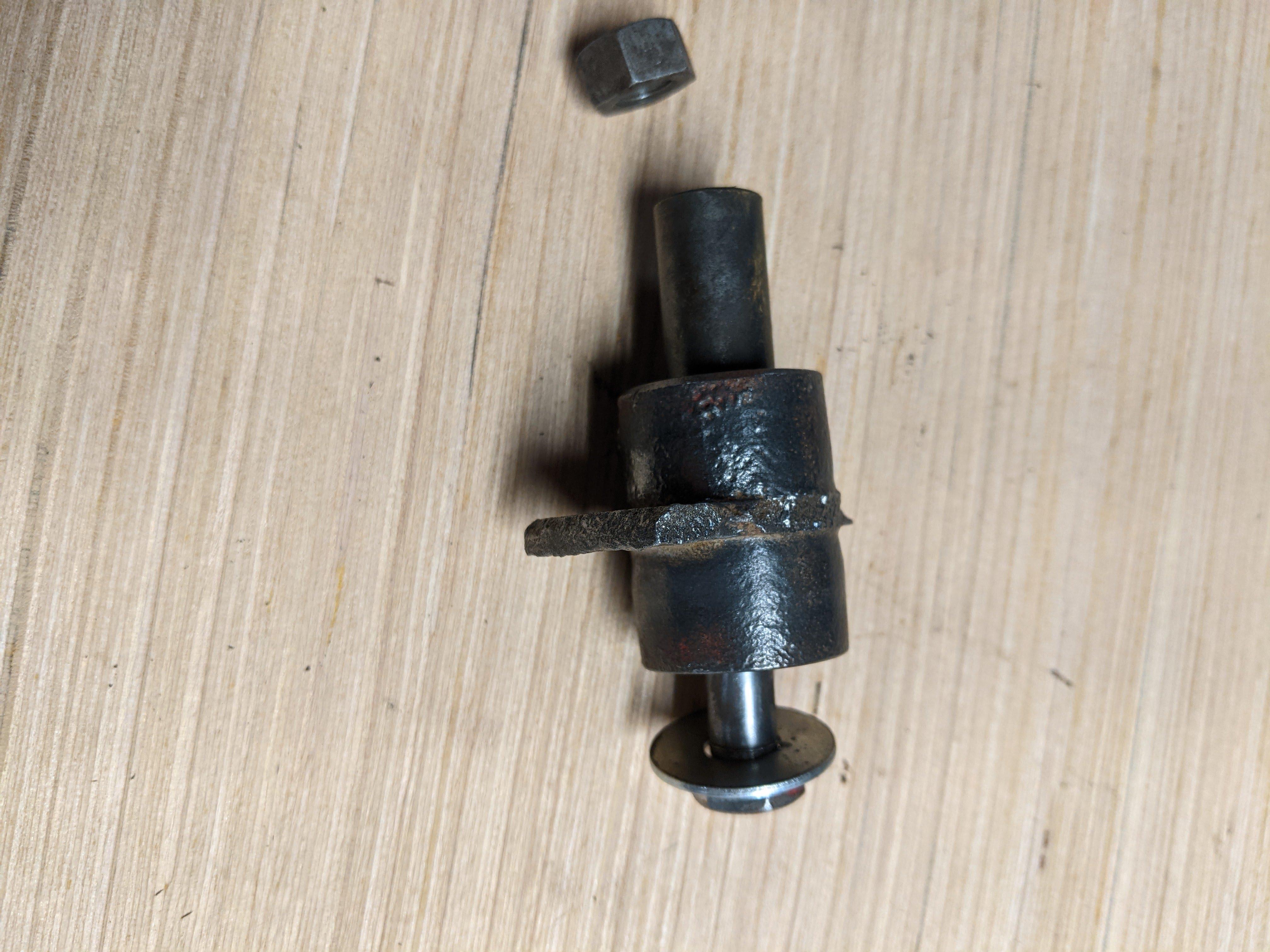 axle of broken caster wheel with bolt and nut.jpg