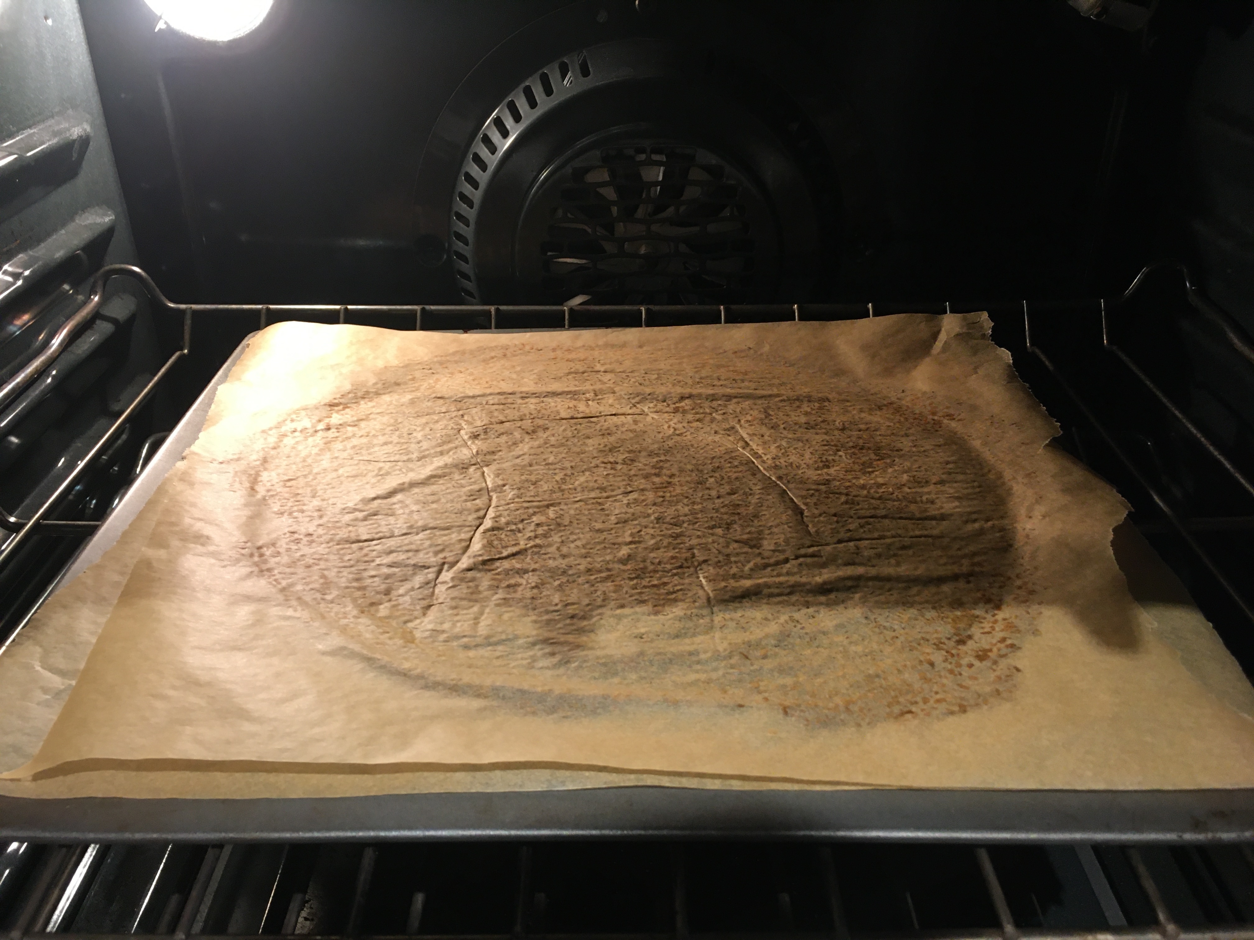 baking in oven with two sheets of parchment paper.JPG