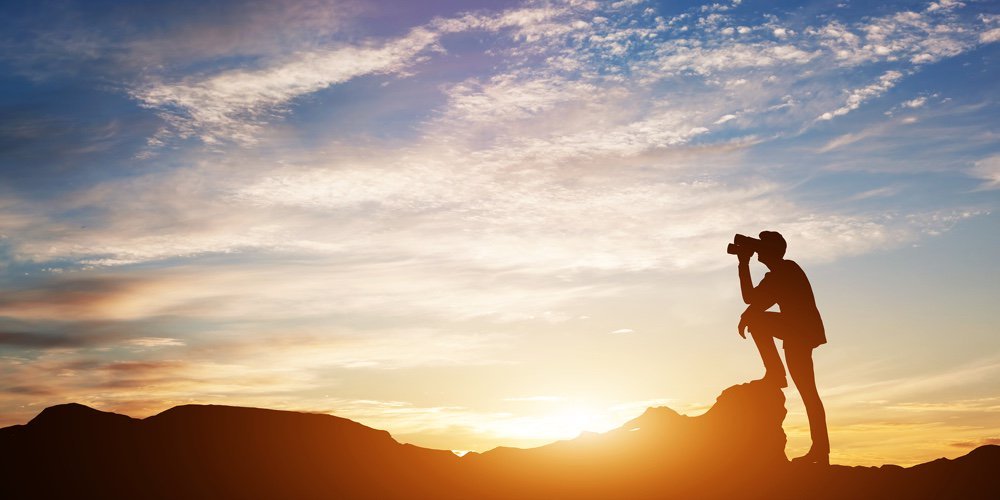 bigstock-Man-standing-on-rocks-looking-208080886.jpg