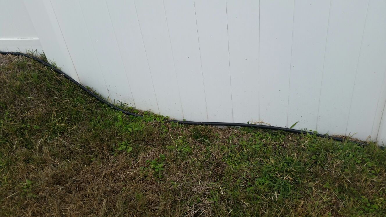 black pipe ran along fence.jpg