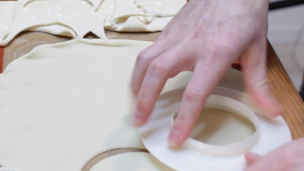 cutting large circles out of pie crust dough.jpg