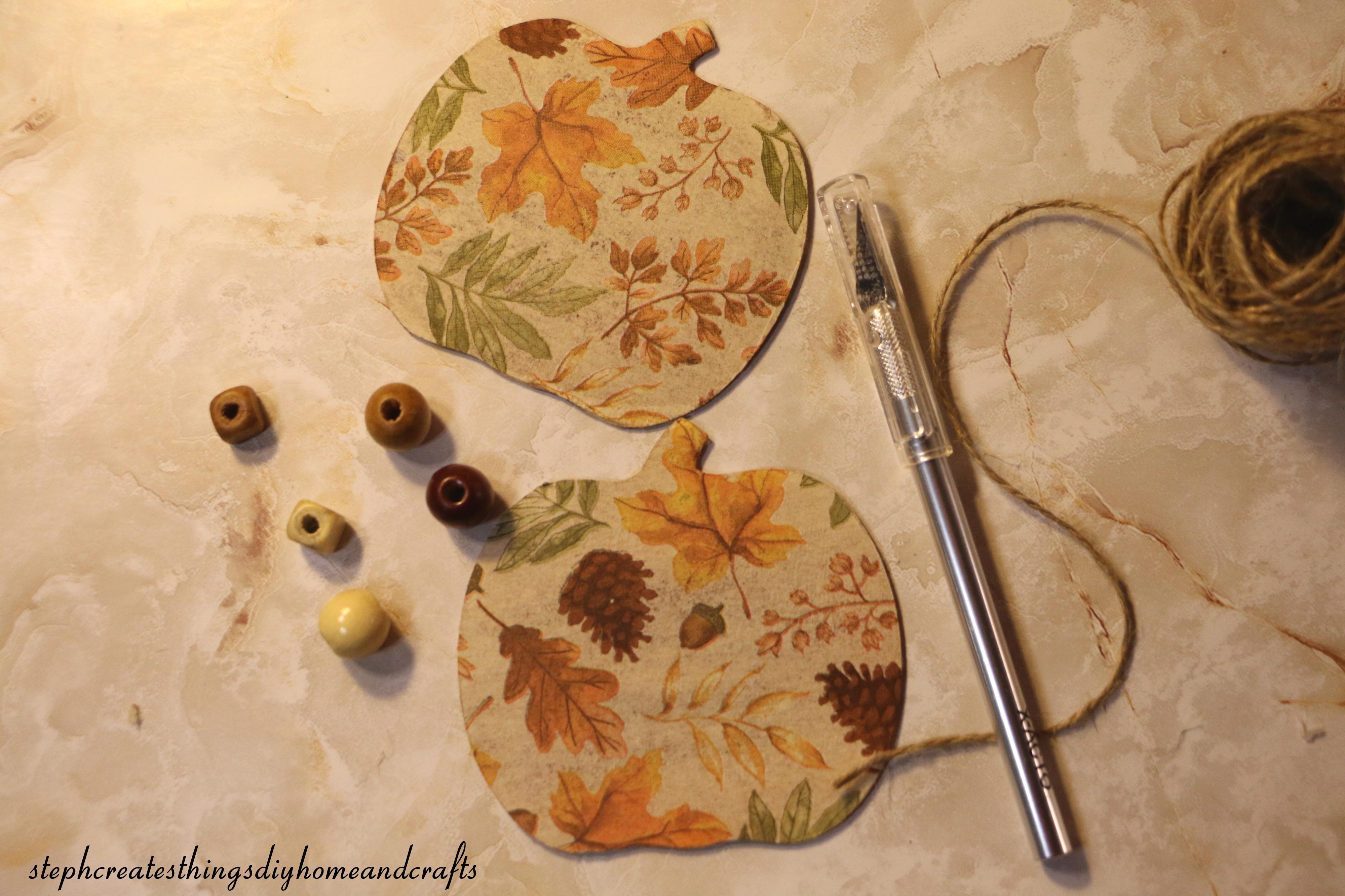 decoupaged wooden pumpkins, twine, craft knife and beads.jpg