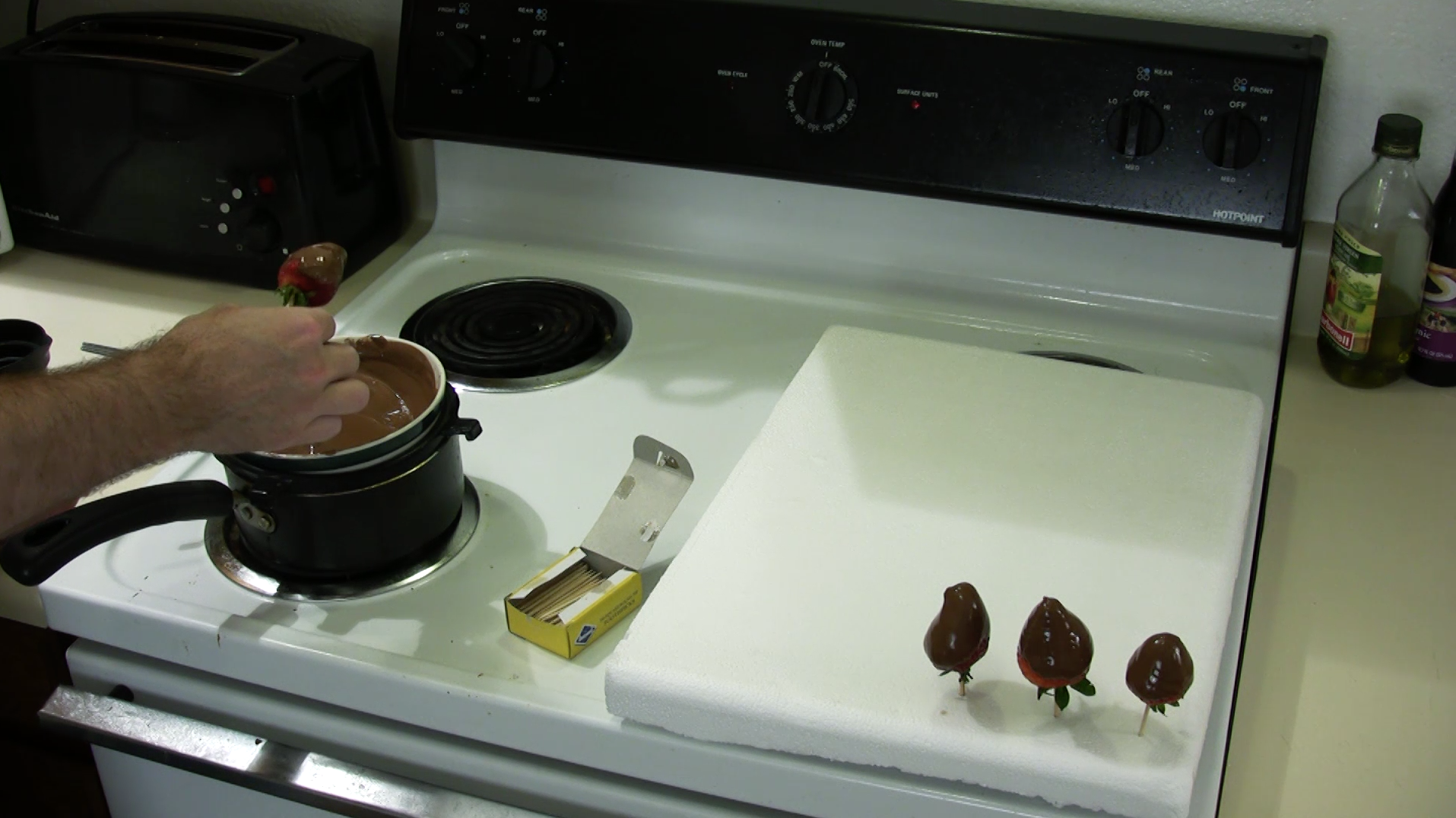 dip strawberry in chocolate and place on styrofoam.png