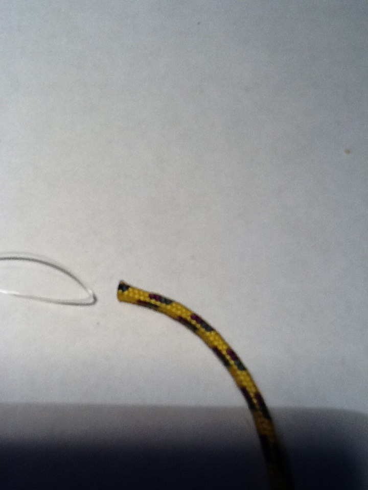 feeding the fishing line through the paracord.jpg