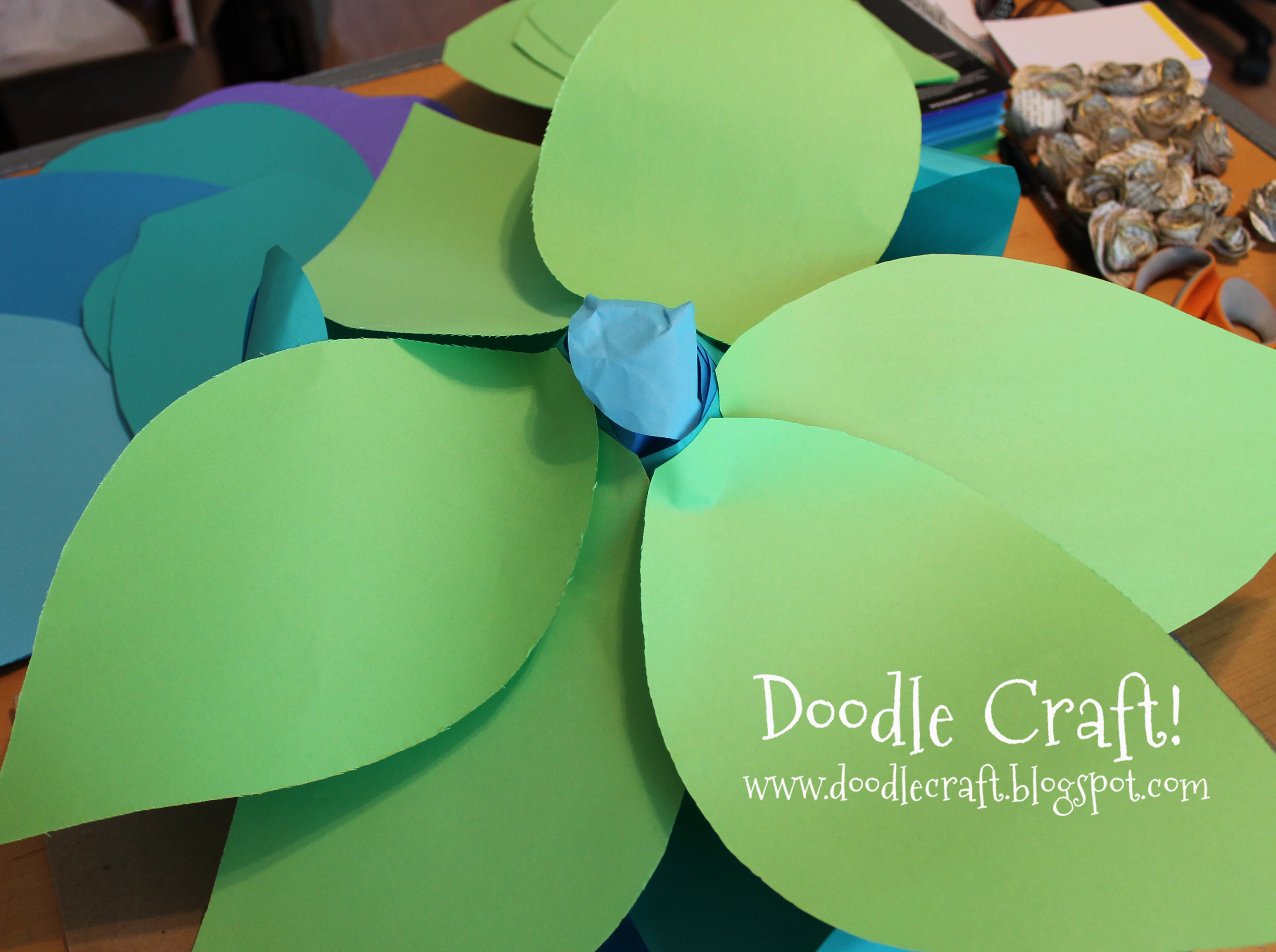 glue leaves on giant paper flowers doodlecraft.jpg