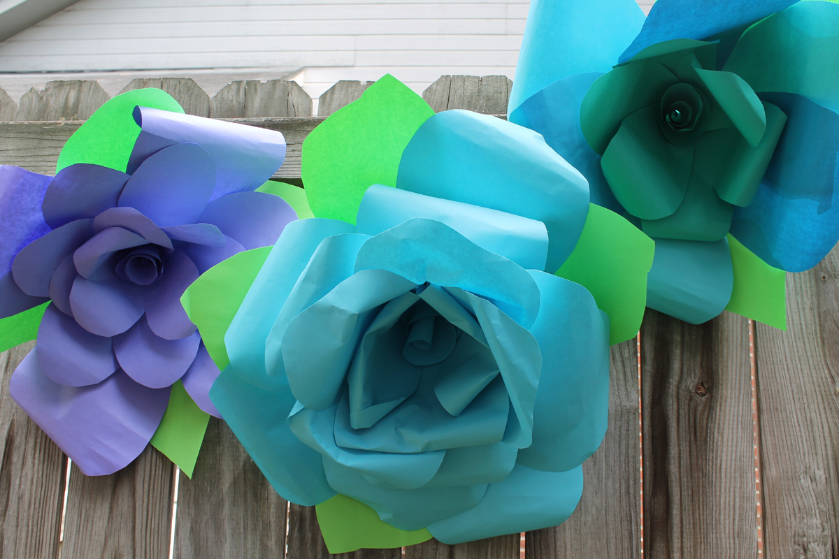 hanging on wood fence paper flowers.jpg