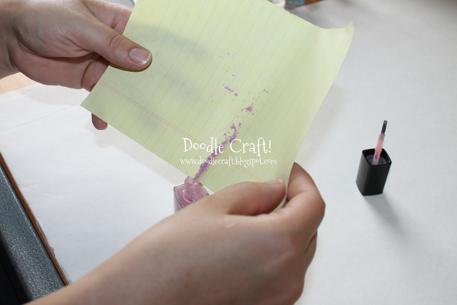 pouring eye shadow into nail polish with paper funnel.jpg