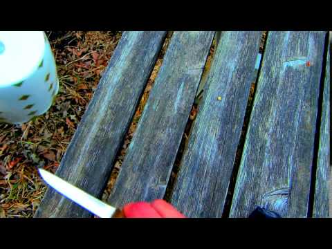 sharpening a knife against the bottom of a ceramic cup