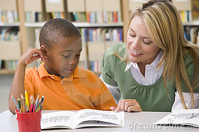 teacher-helping-student-reading-skills-6081840.jpg