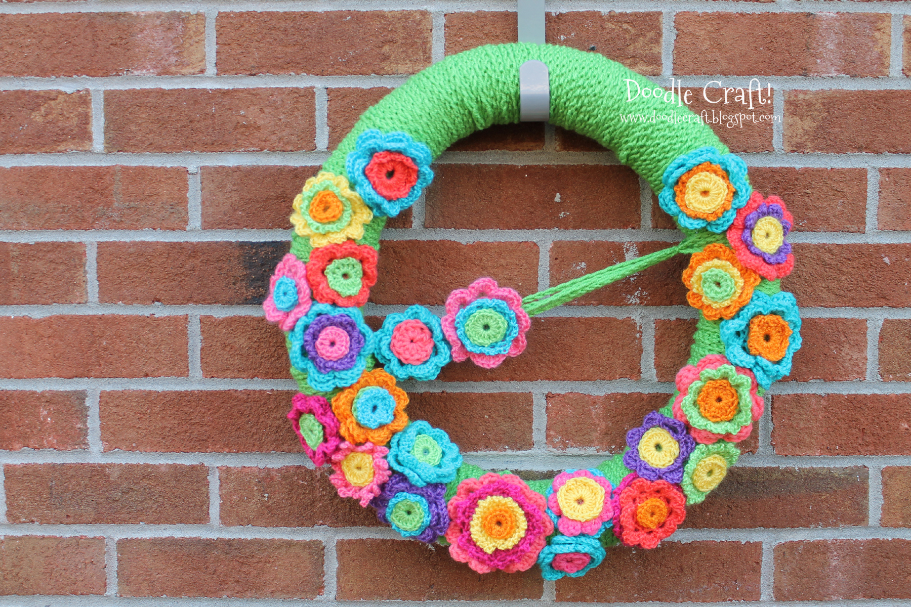 wreath made of crochet rosettes colorful yarn flowers.jpg