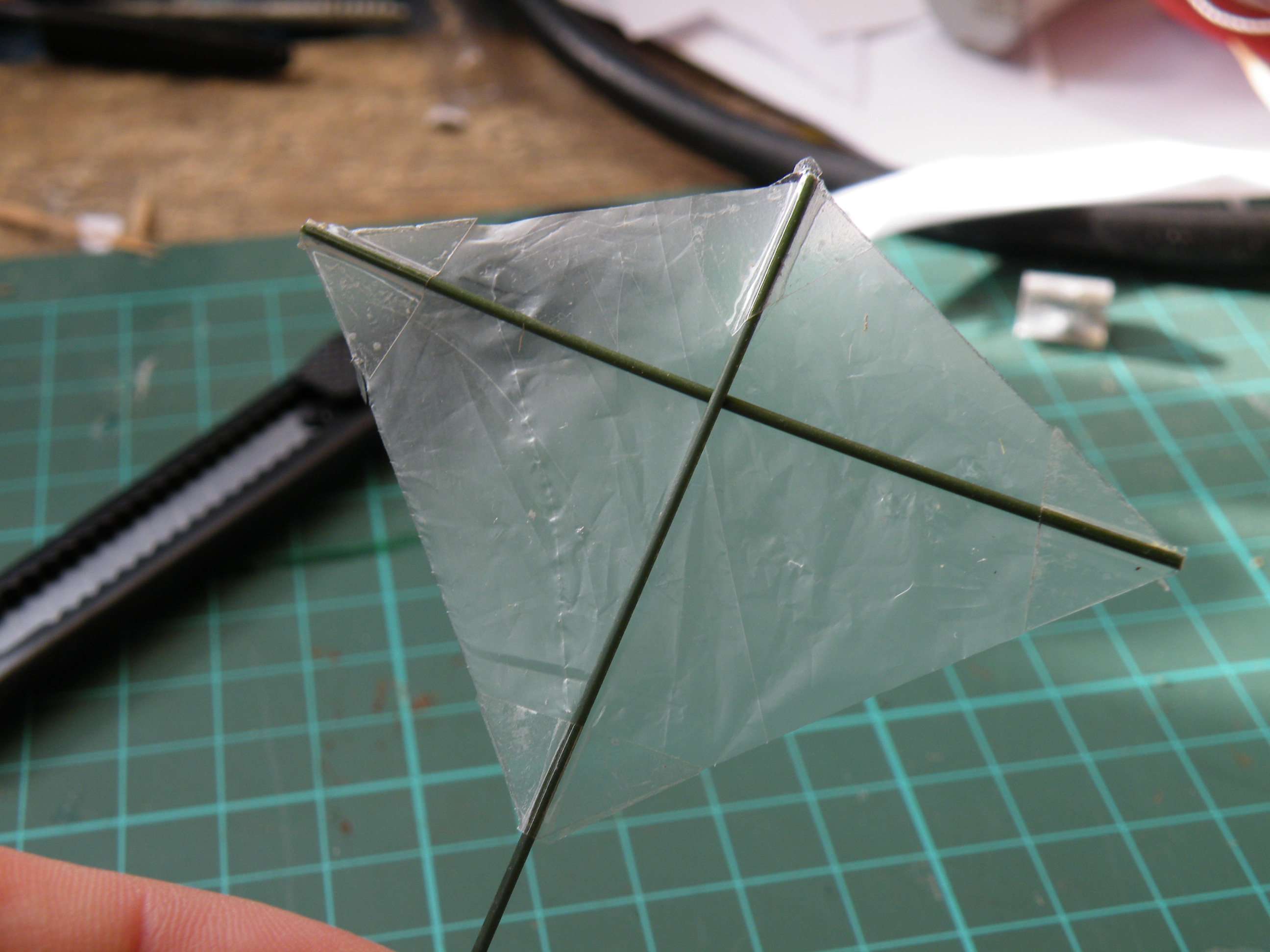 Make a tiny, transparent kite from broom bristles.