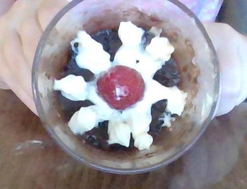 Brownie Mix Mug Cake With Orange Juice and Cream Cheese Frosting on Top.