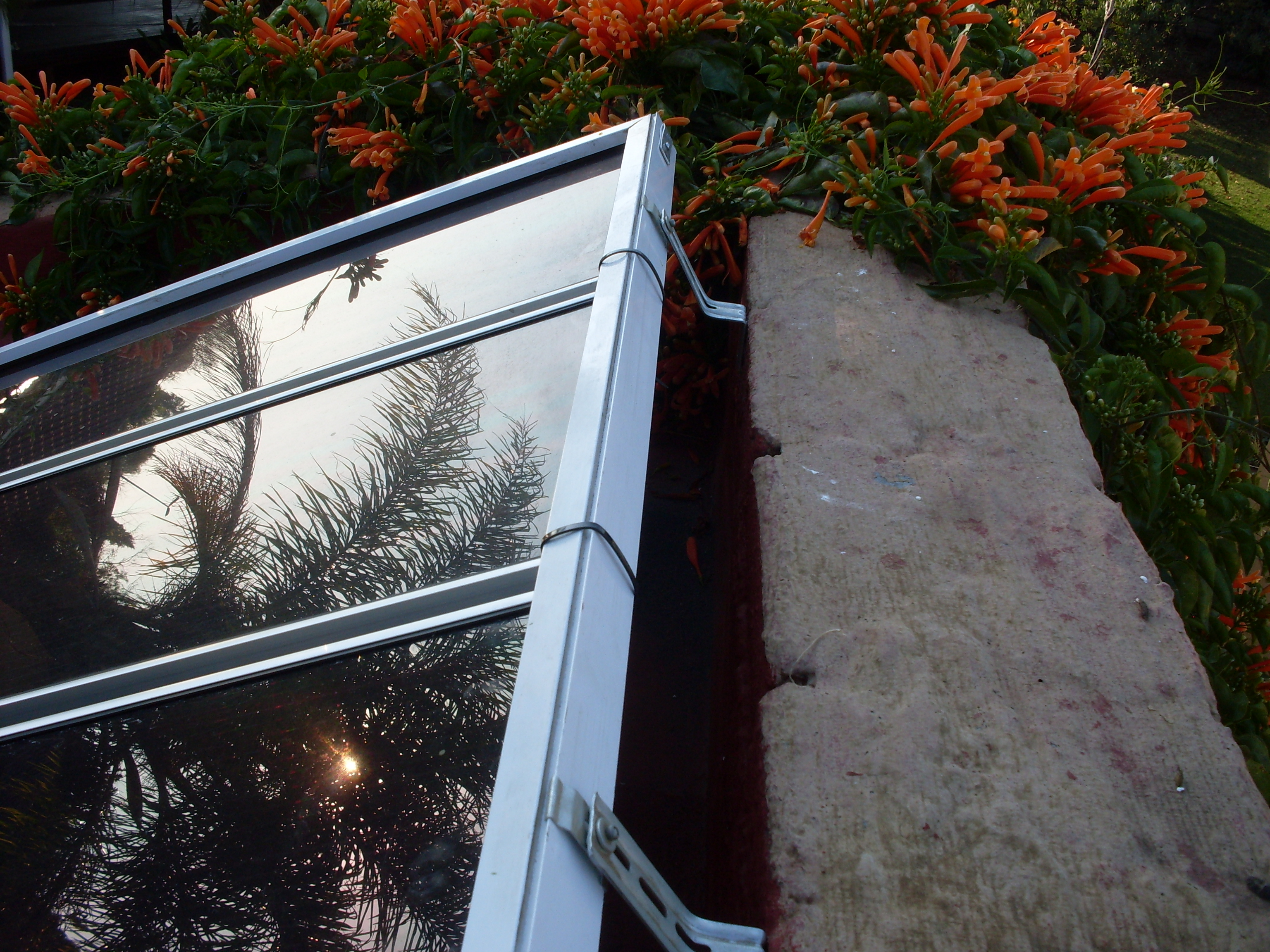 Mounting multiple solar panels using old window blind rails and hardware