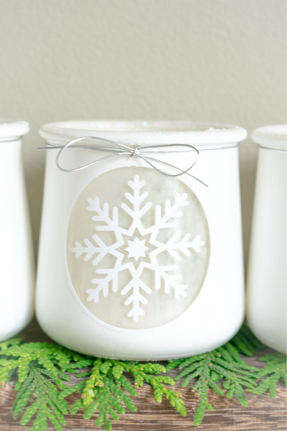 How-to-repurpose-Oui-Yogurt-Jars-to-beautiful-white-DIY-winter-votive-holders-with-spray-paint,-vinyl,-and-glitter-for-a-snowy-christmas-craft-or-table-centerpiece-11.jpg