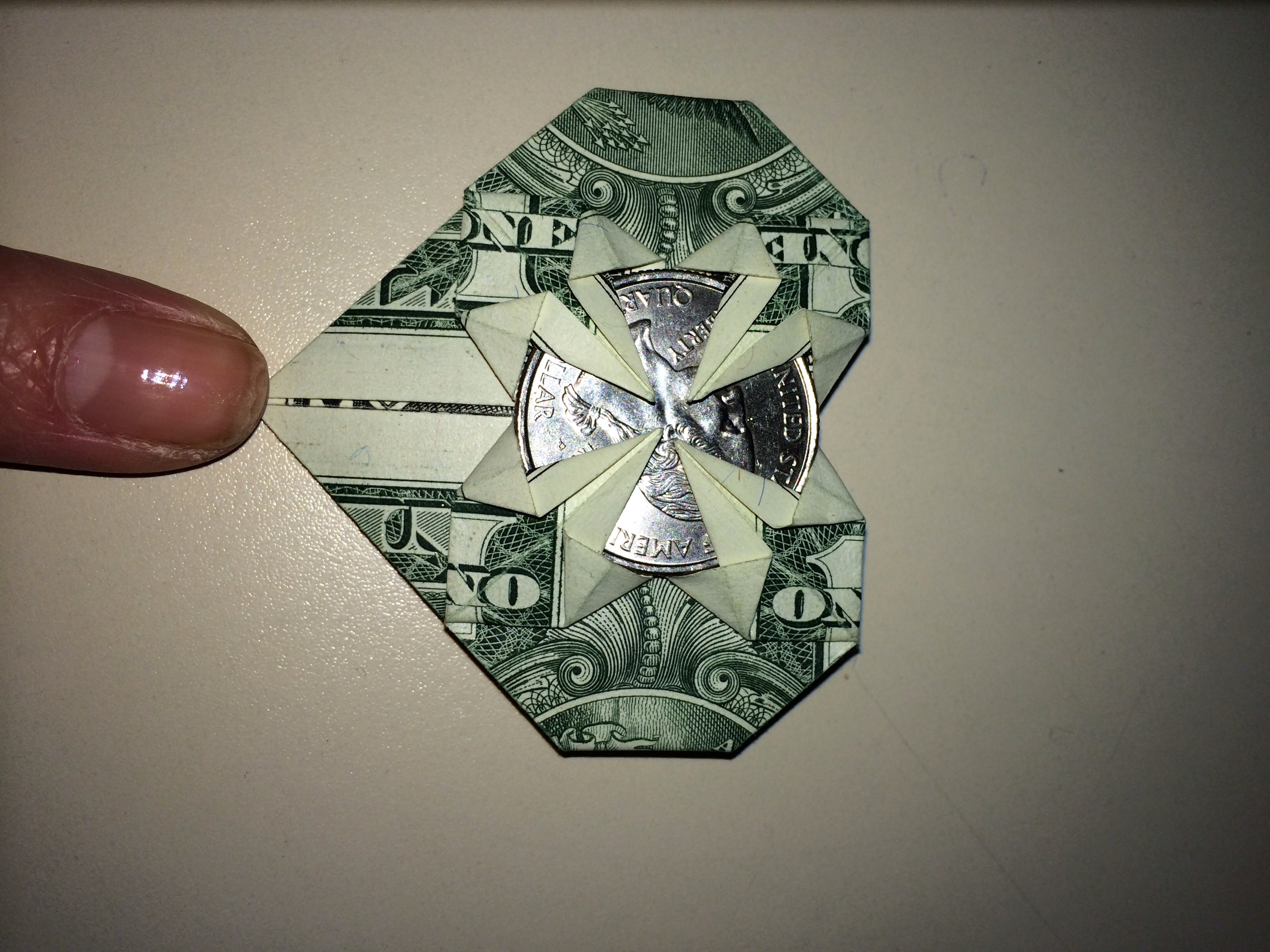 Dollar Origami Heart Holding Quarter