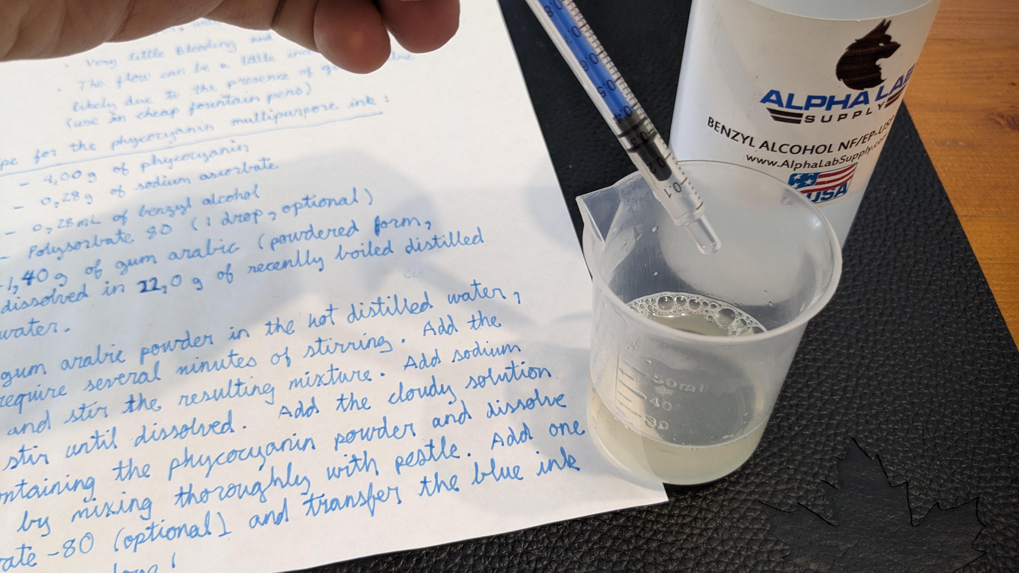 Step 3- Draw 0.28 mL of benzyl alcohol with a syringe, then add it to the gum arabic solution and stir well.jpg