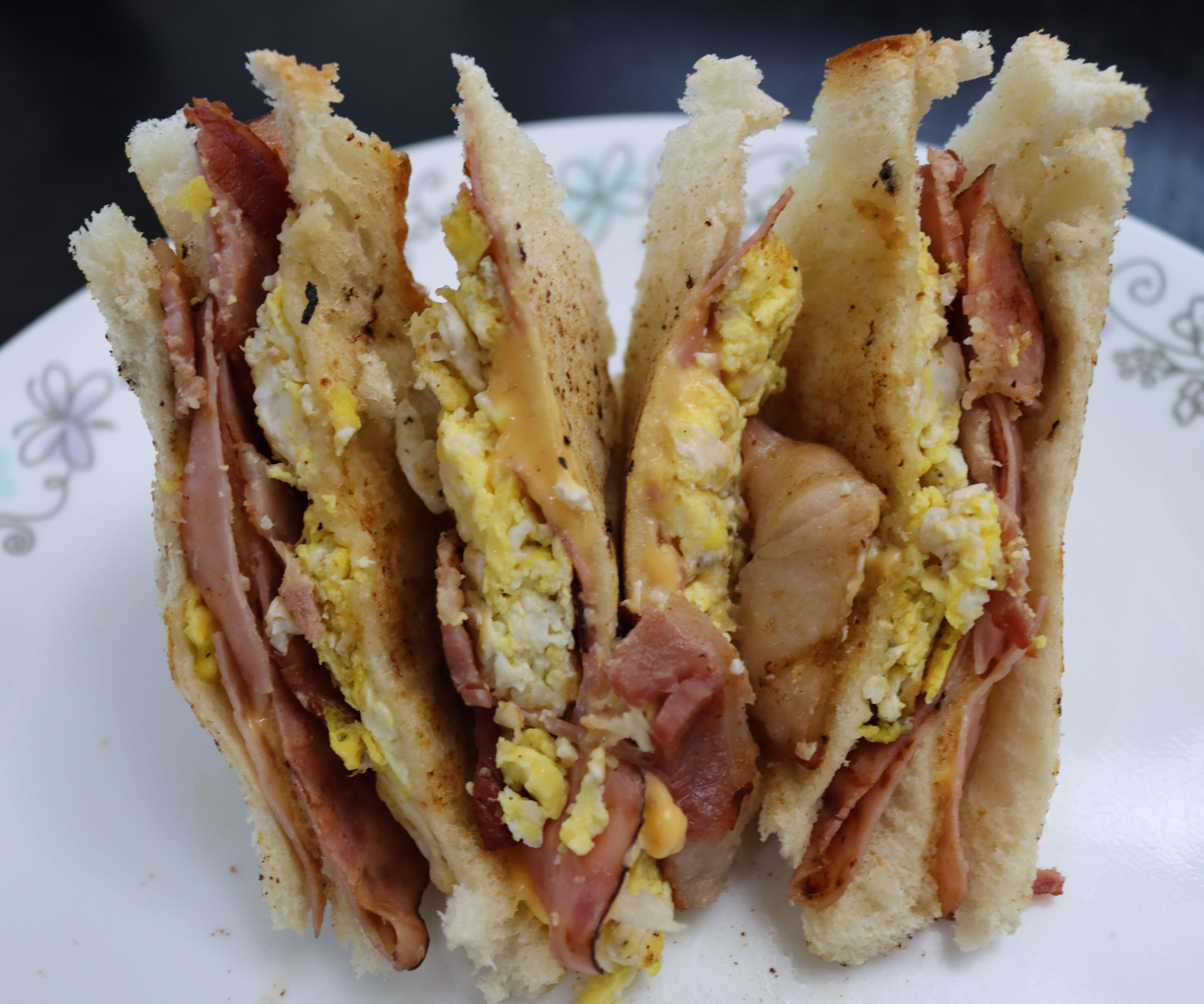 Toasted Sandwich With Ham, Bacon, Cheese, and Egg