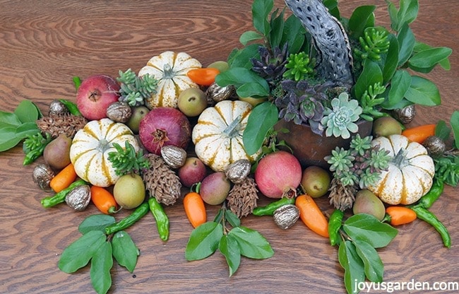 Pomegranates-white-and-orange-minipumpkins-magnolia-cones-gilded-walnuts-orange-pepppers-green-peppersm-succulent-cuttings-and-foliage.jpg