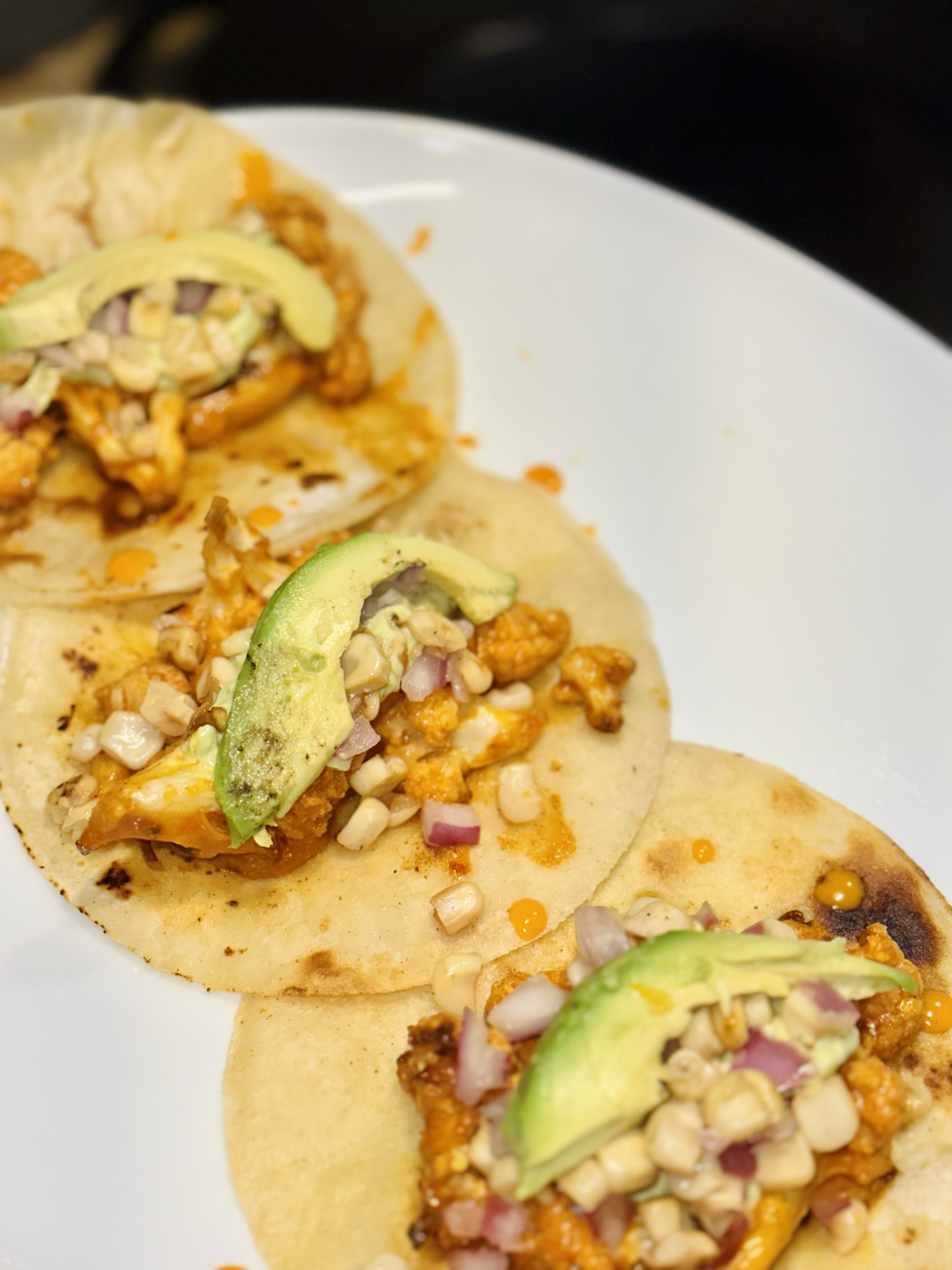 Baked Buffalo Cauliflower Tacos With White Corn Salsa and Avocado Creme Sauce